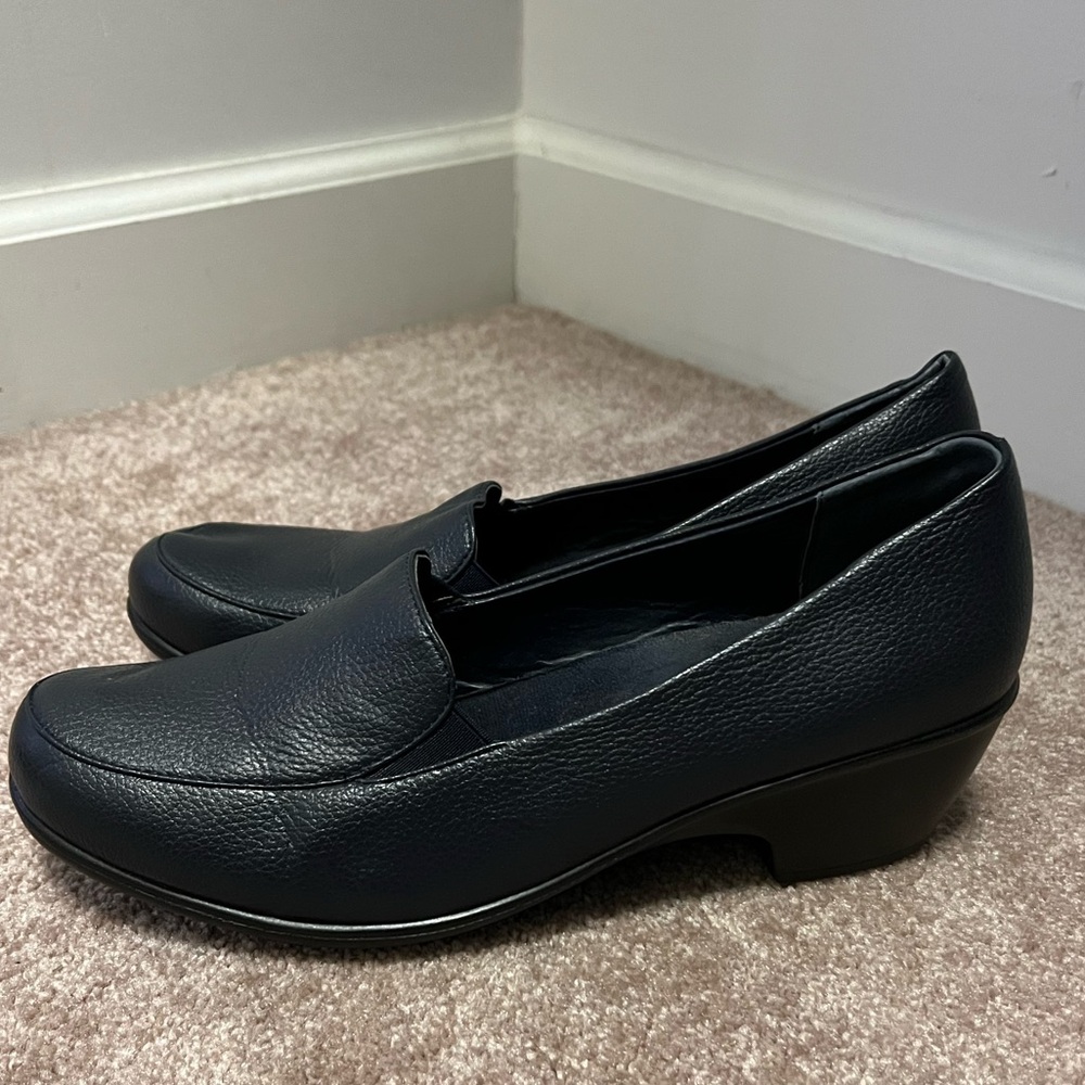 Navy loafer dress shoes with small heal.